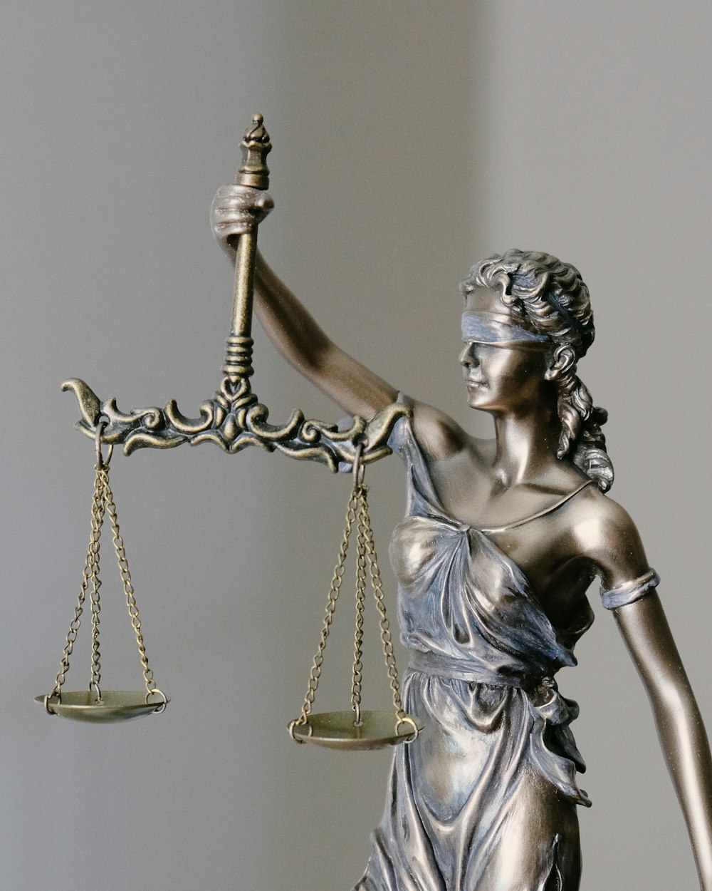 Bronze statue of Lady Justice holding scales